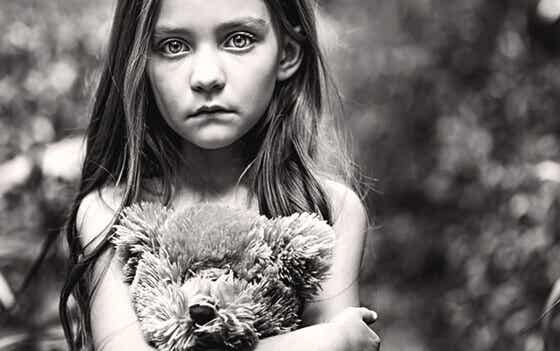sad girl holding teddy bear