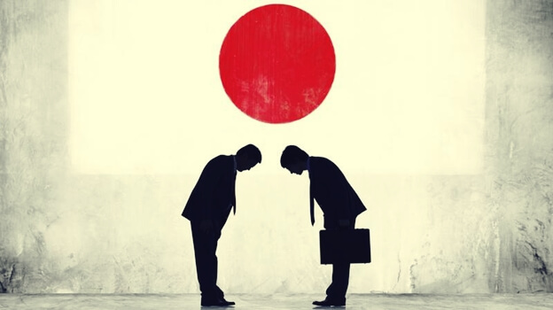 personas saludándose bajo sol naciente representando la psicología japonesa