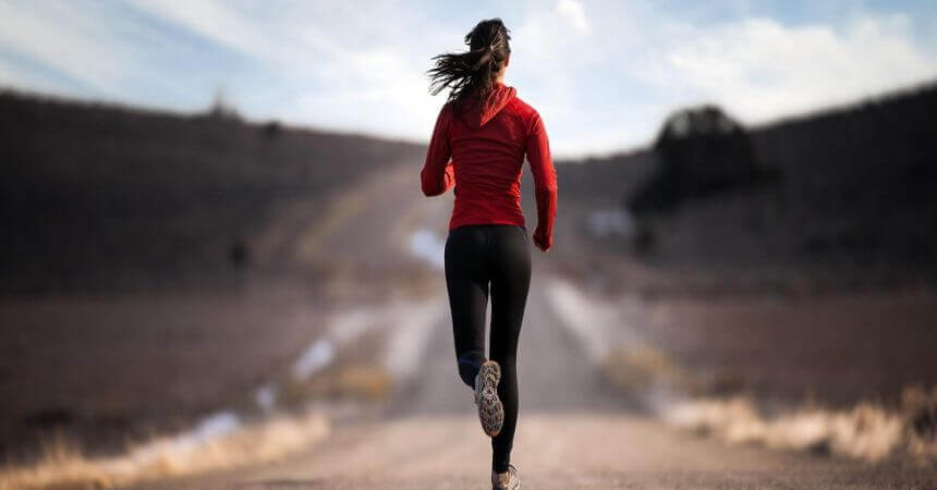 Mujer corriendo por la carretera