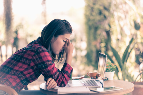 Tired girl showing how Facebook decreases emotional well-being.