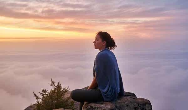 chica sentada en el silencio de una montaña simbolizando la dificultad del amor en las personas inteligentes