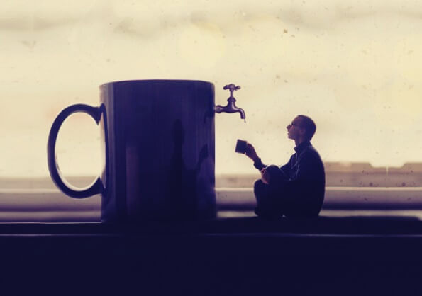 hombre ante taza gigante teniendo experiencias visionarias