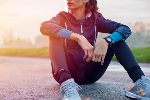 A woman sitting on the pavement.
