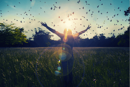 Woman with open arms enjoying her happiness