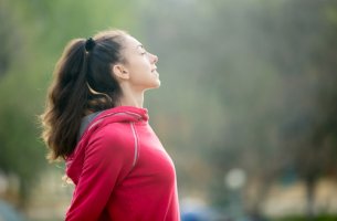 Mujer respirando pensando en la importancia de la inteligencia emocional en el deporte