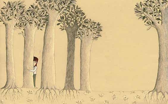 niña escondida tras árbol simbolizando la edad emocional del desamor