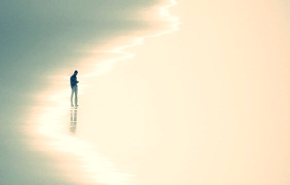 man on the beach symbolizing postmodern loneliness