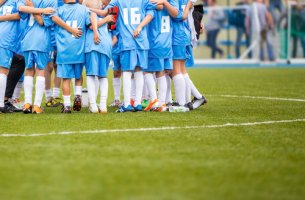 Niños reunidos en el campo de fútbol