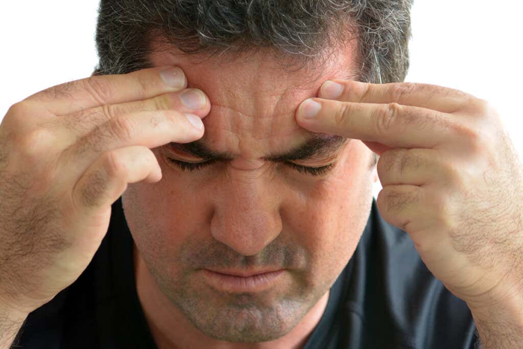man with headache symbolizing When does anxiety become a disorder?