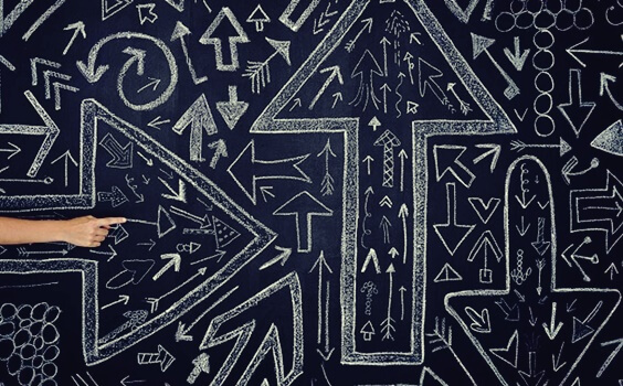 Arrows going in different directions symbolizing chaos theory.