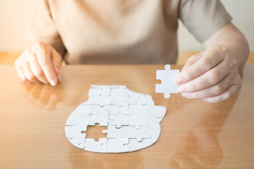 Mujer haciendo un puzzle de un rostro