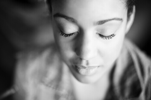 Mujer con los ojos cerrados intentando desconectar la mente