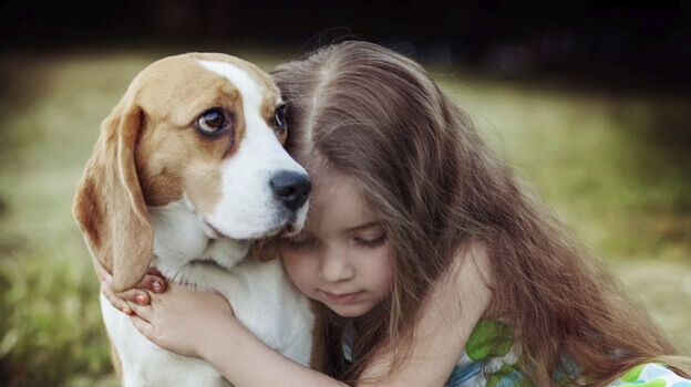 Niña abrazando a su perro