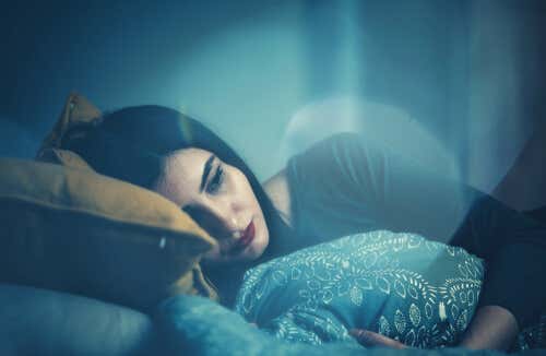 Sad woman in bed thinking of saying goodbye