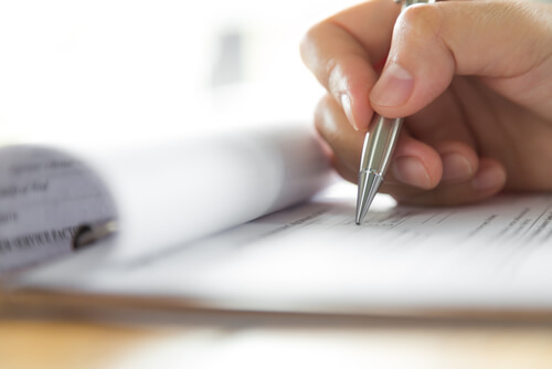 Persona escribiendo un informe psicológico forense