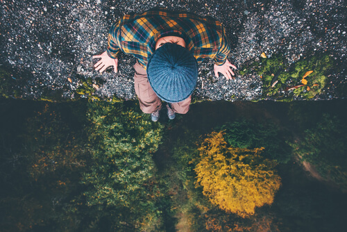 A man sitting in a forest.