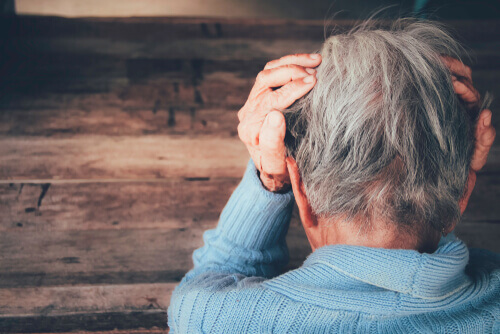 Person with hands on head for dementia