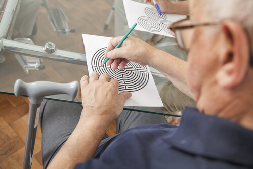 Hombre haciendo ejercicio de estimulación cognitiva con el neuropsicólogo