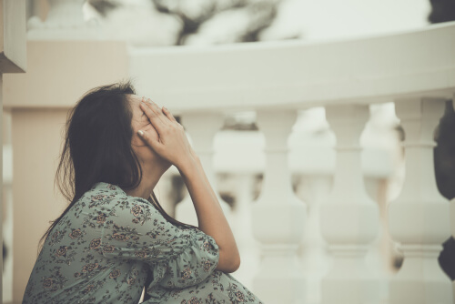 Sad woman on the balcony