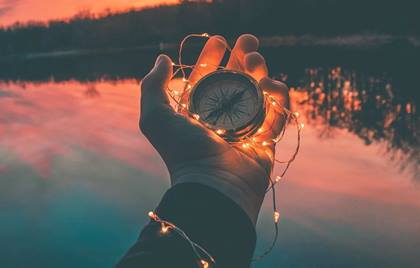 Mano con brújula representando las coincidencias