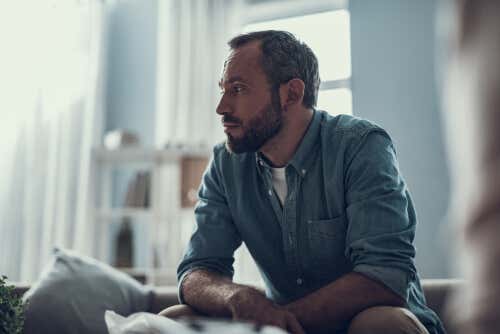 Worried man feeling lonely at home