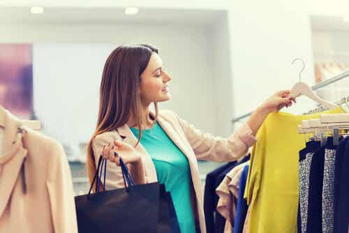 Woman shopping for clothes, showing that treating yourself can be positive.
