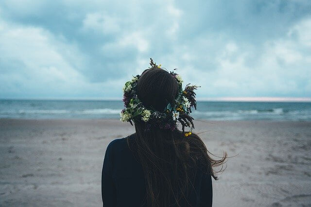 Mujer con corona de flores de espalda