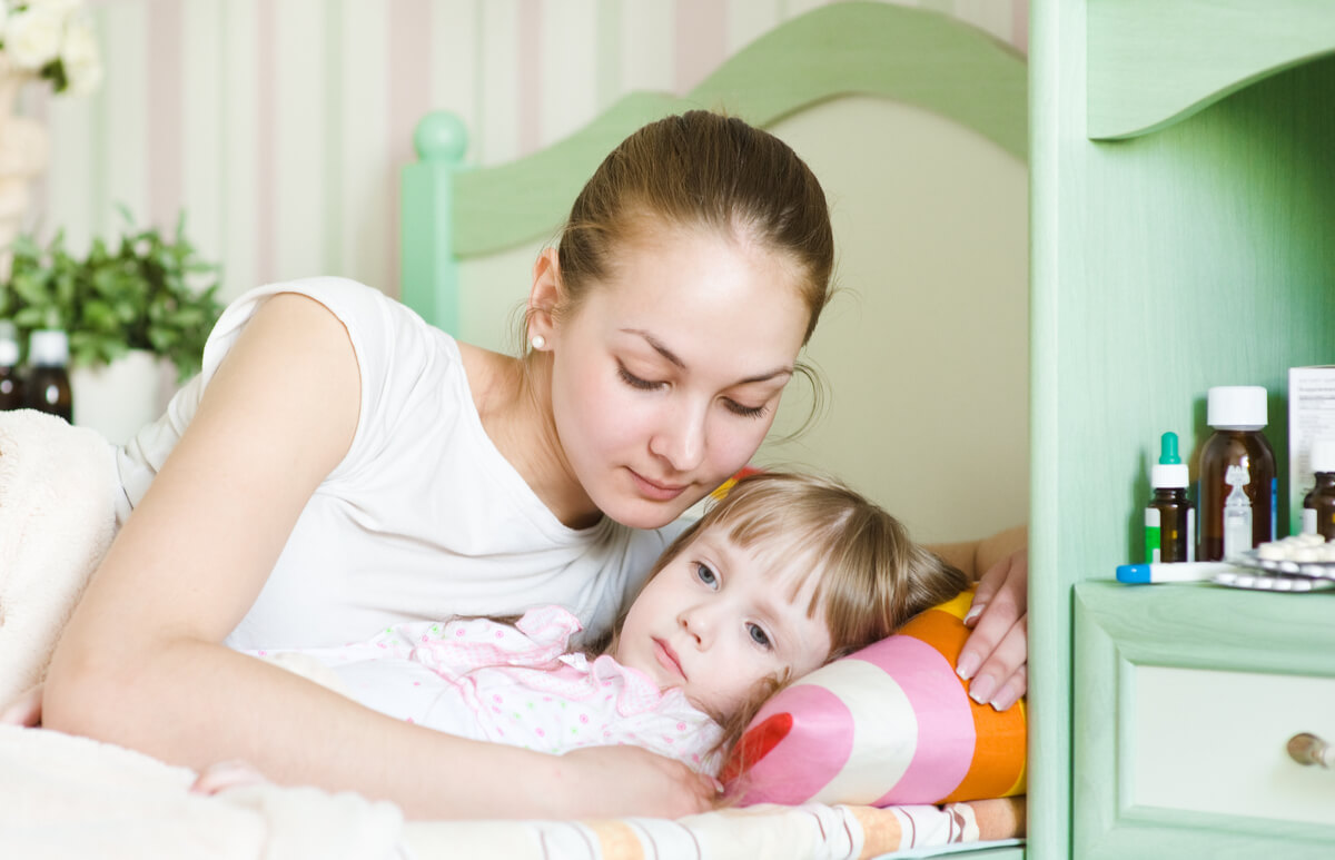 Mother with her daughter in bed