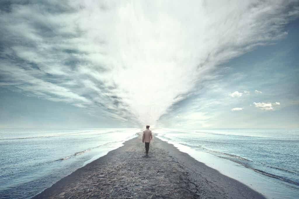 Man walking towards the sea thinking about Existential Therapy