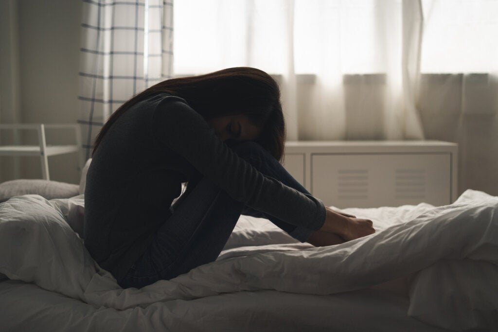 Woman with depression in bed