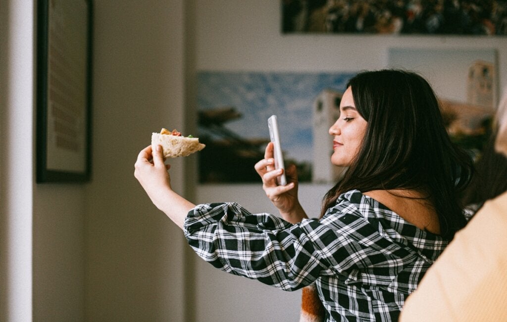 Girl taking photos of her food representing food influencers