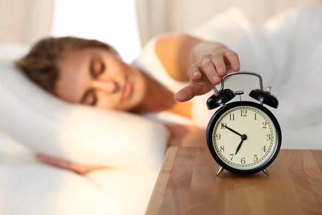 Woman turning off the wake up