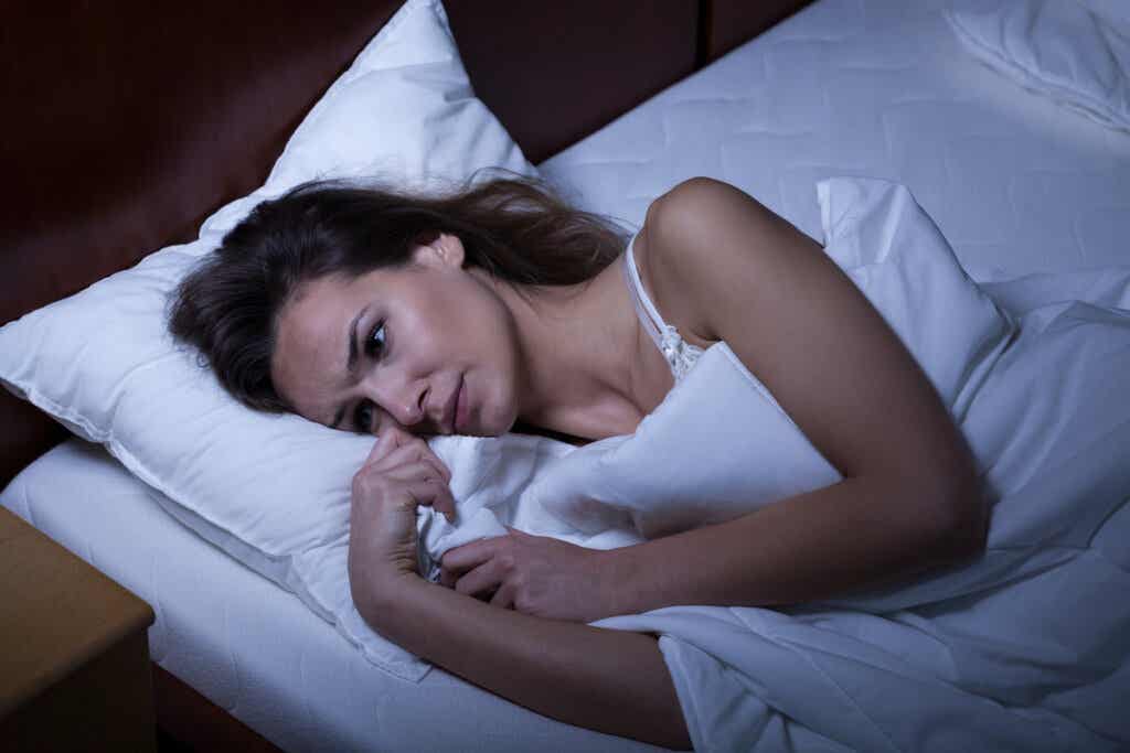 Woman in bed trying to sleep