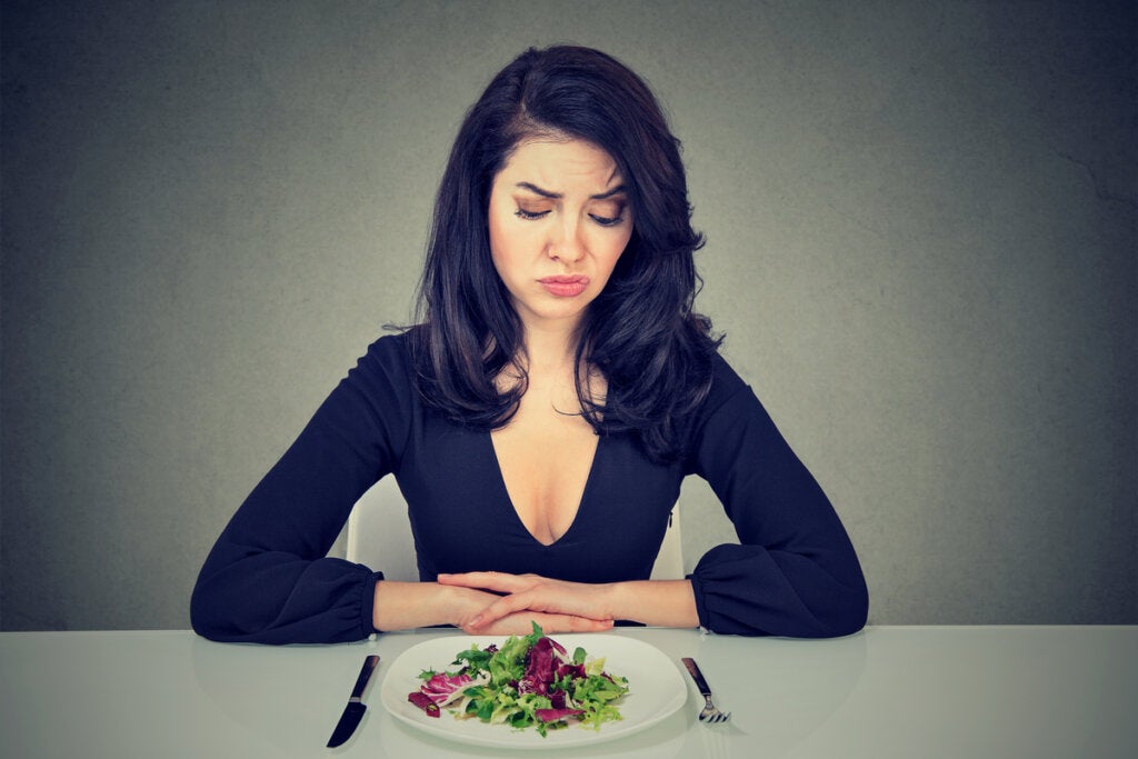 Woman thinking that stress modifies the perception of taste