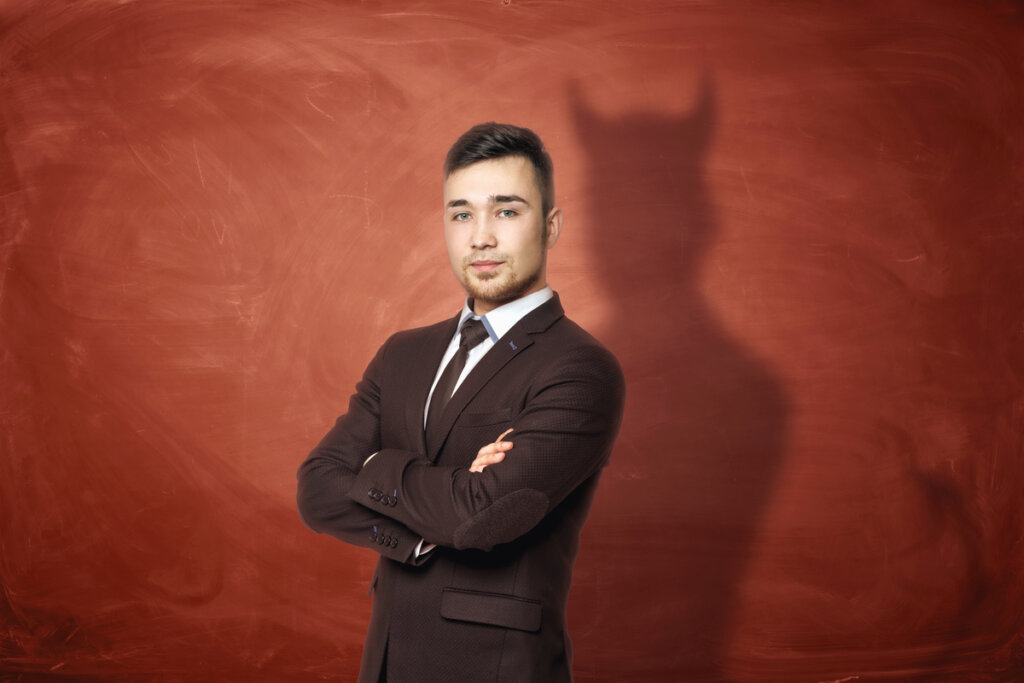 Evil leader reflecting a shadow of evil symbolizing Bonhoeffer's theory of stupidity