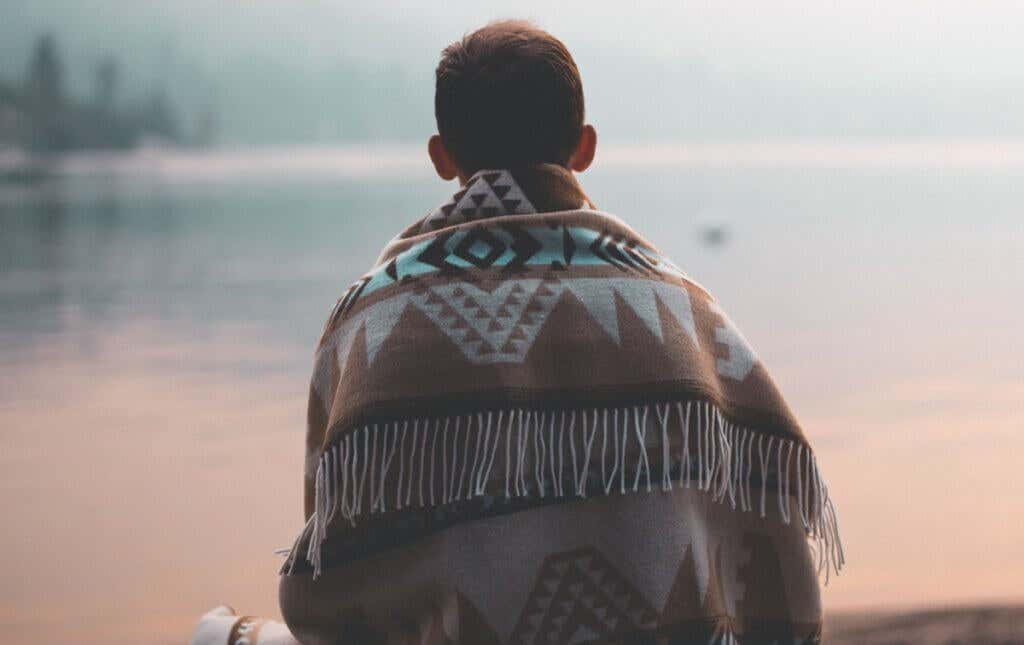 Boy from the back with a blanket thinking about how to be oneself