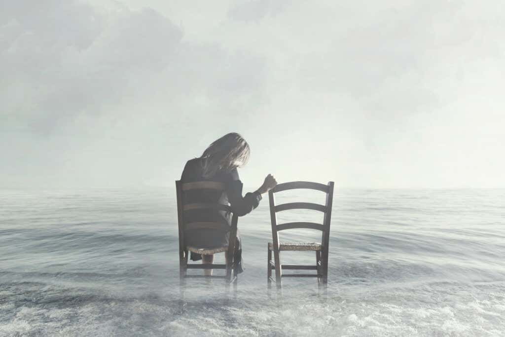Frau auf einem Stuhl im Meer träumt vom Tod