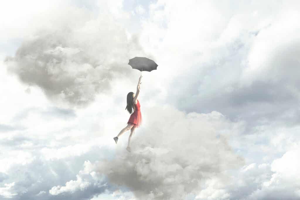 Mujer volando con un paraguas entre nubes pensando que no hay límites