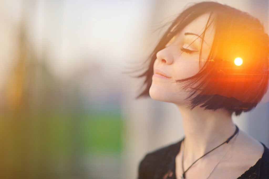 Woman with eyes closed with a light in her mind working on self-compassionate self-talk