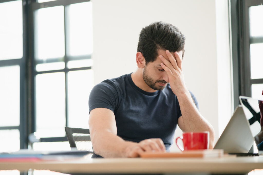 man pressing self-destruct “button”: