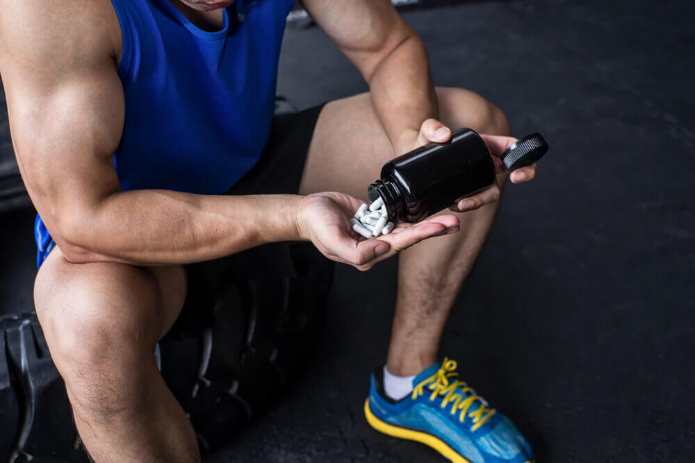 Man with addiction to physical exercise consuming substances