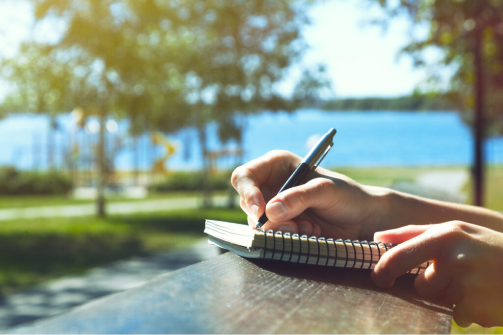 Woman writing outdoors