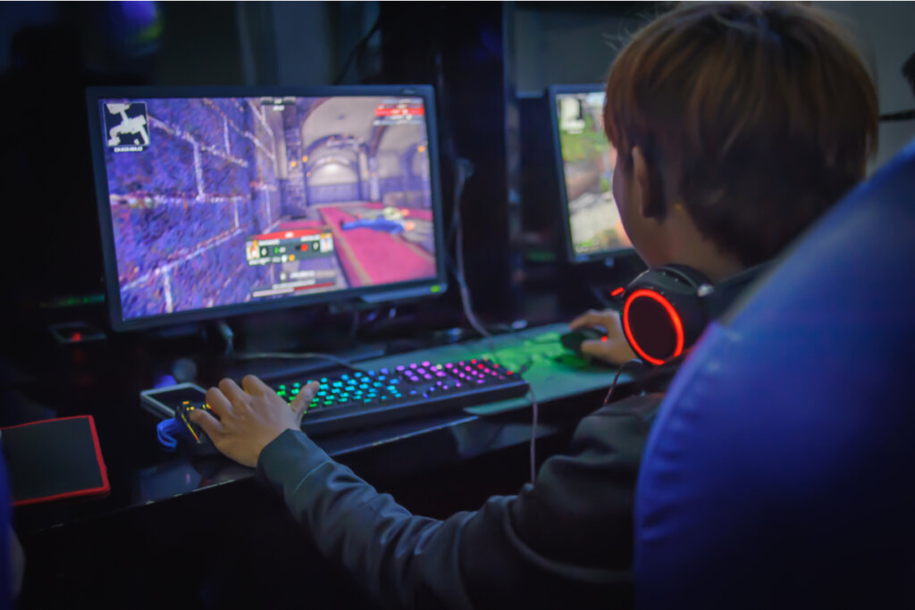 Boy playing video games in his room