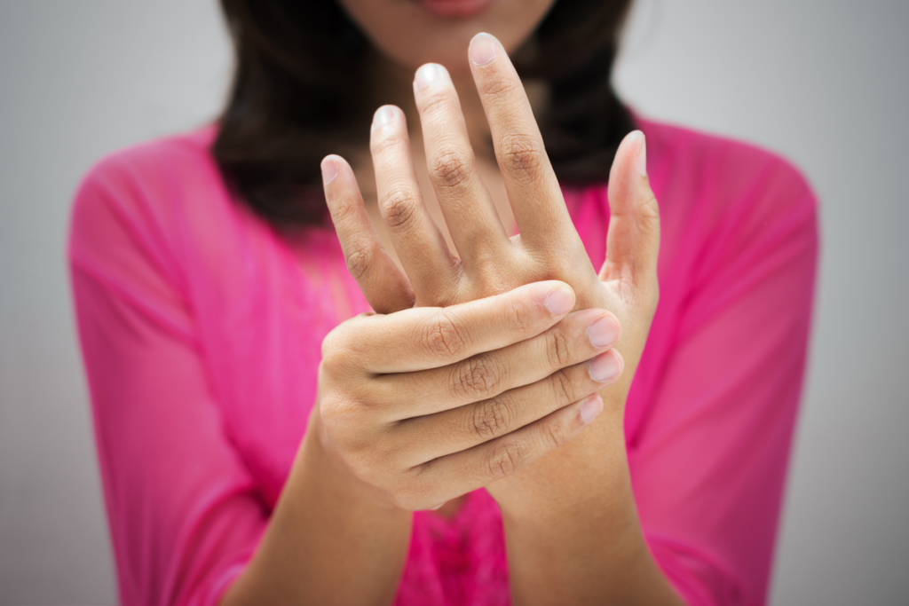 Woman holding her hand for numbness