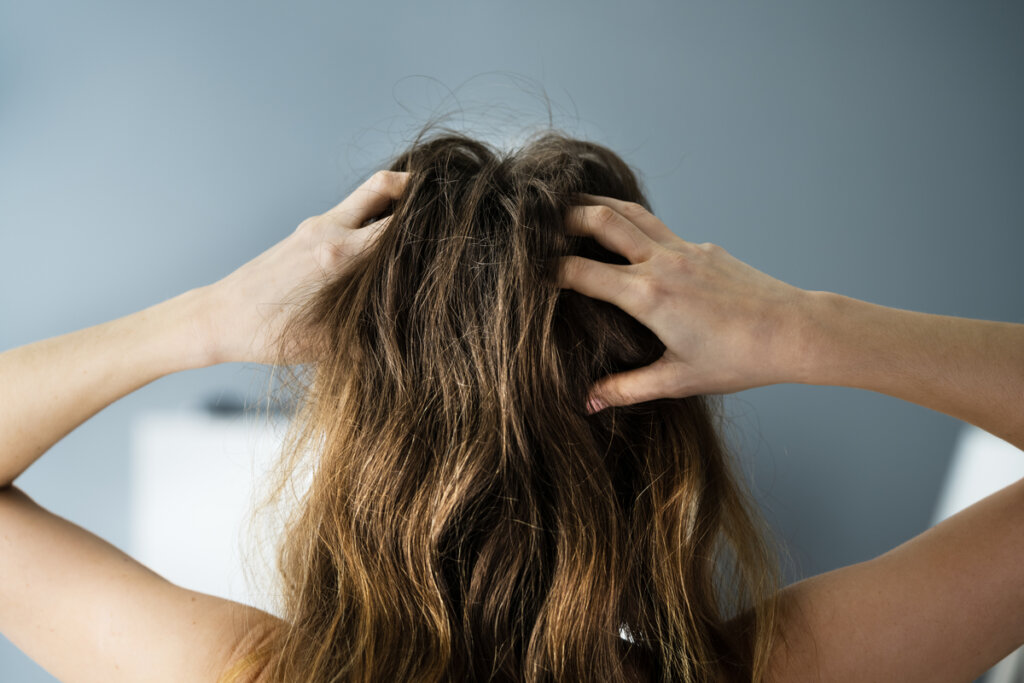 Woman with hands on head