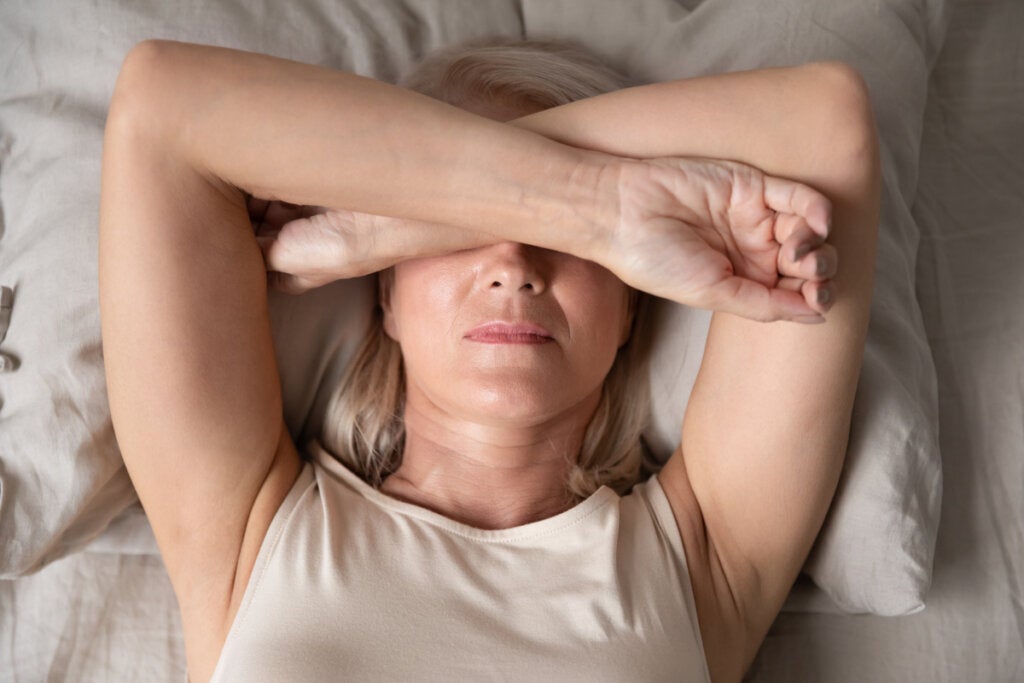 Senior woman with insomnia thinking that worries are more intense on Sunday nights