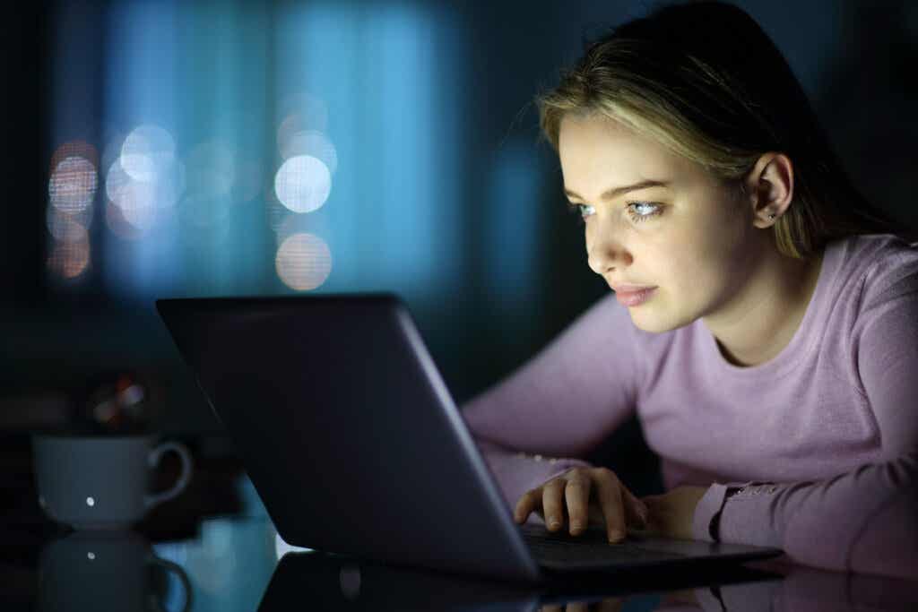 Donna che legge sul computer che raggiunge la massima concentrazione.