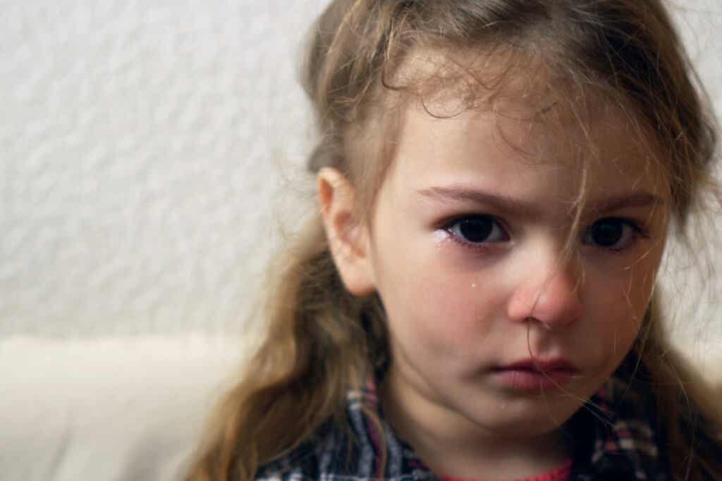 Sad girl crying, showing anxiety in children.
