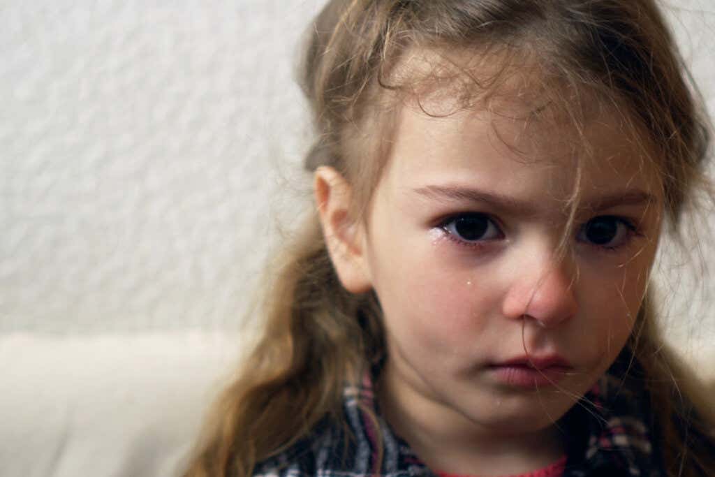 Trist jente som gråter og viser angst hos barn.