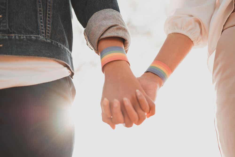 A gay couple walking hand in hand.